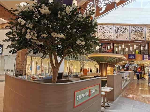Emporio Artari floral kiosk: chic pop-up activation space for networking events.