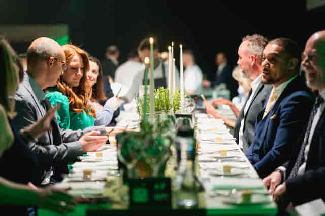 Elegant banquet setup with fine china for corporate networking event at QEII Centre.