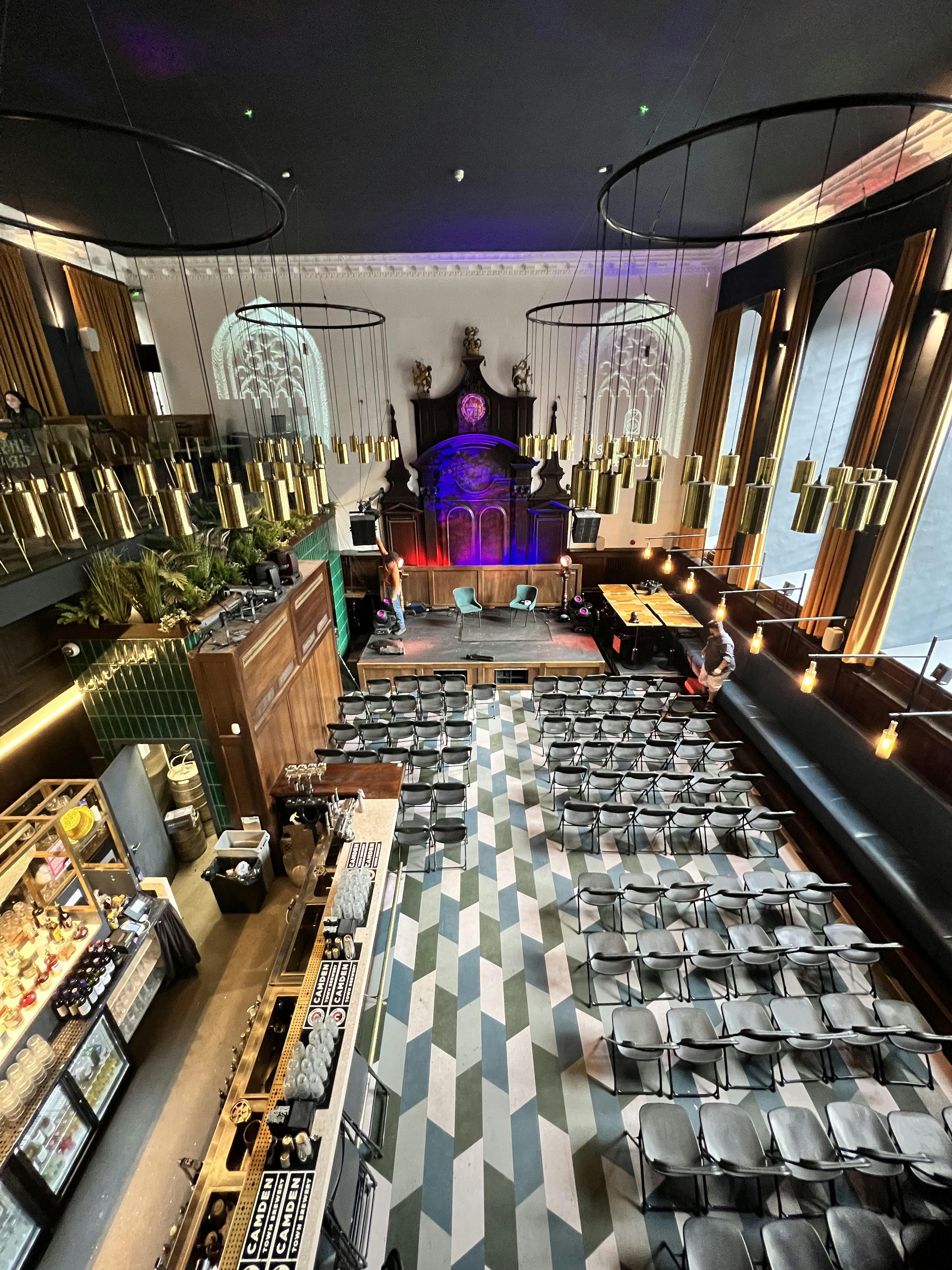 Stylish event space with elevated stage, perfect for conferences and social gatherings.
