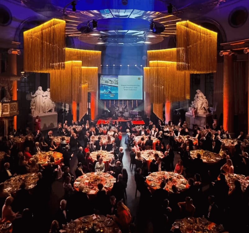 Gala dinner in Skeppsholmen concert hall with metallic fringe decor for luxury corporate events.