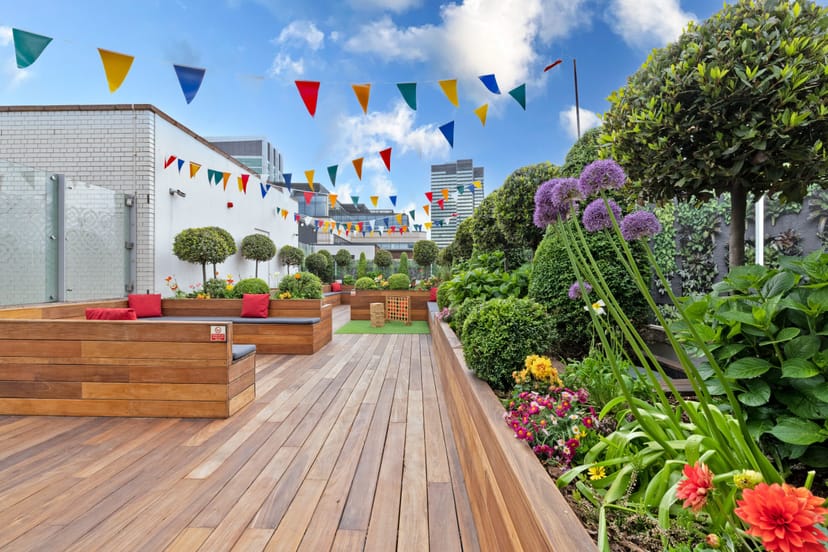 Rooftop terrace with tiered wooden seating for networking and team-building events.
