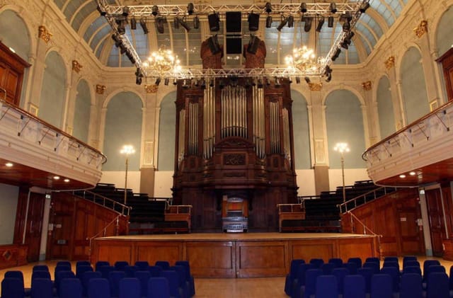 Thrive heritage event hall with pipe organ for corporate presentations and formal ceremonies.