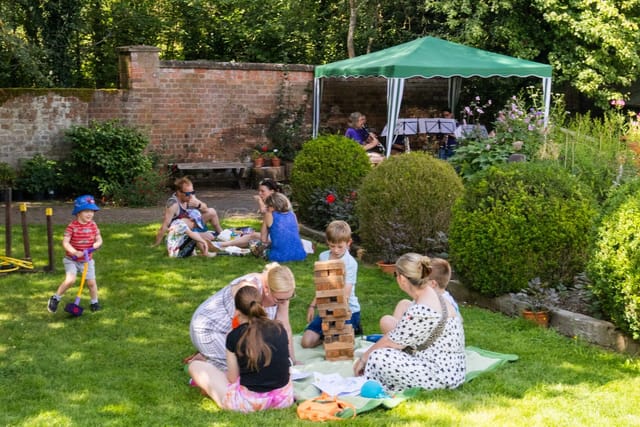 Outdoor corporate retreat at Thrive Event Hall featuring shaded catering and lawn games.