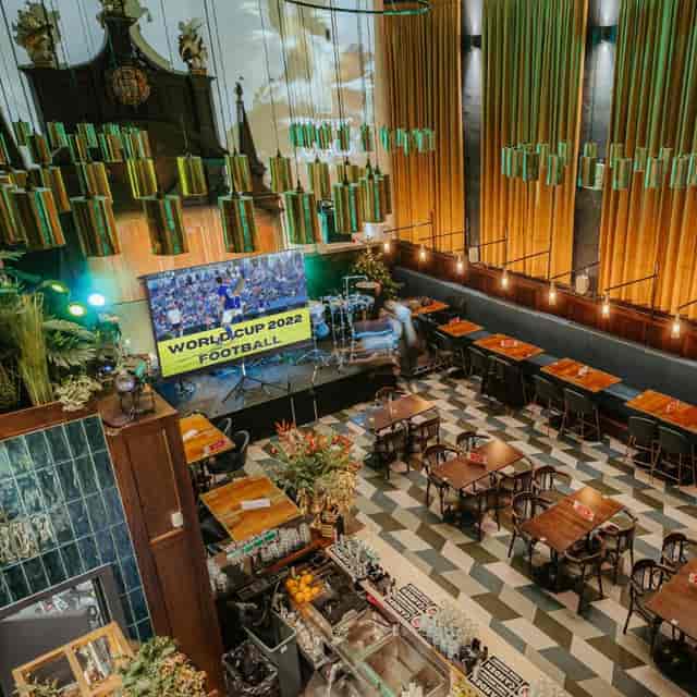 Vibrant Mezzanine event space for World Cup 2022 viewing party with large screen.