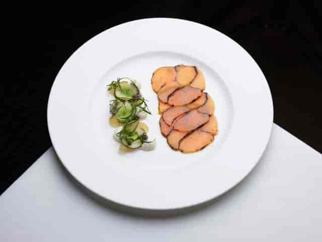 Elegant plated dish with protein and salad at Bechstein Hall for fine dining events.
