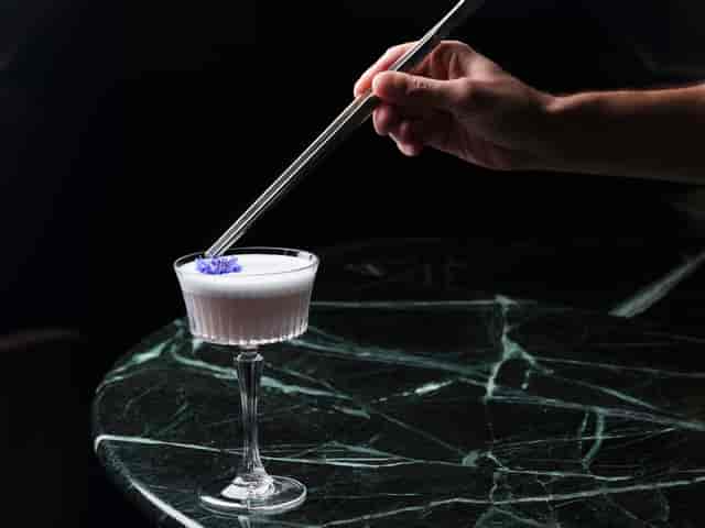 Meticulously crafted cocktail with edible flowers at Bechstein Hall's upscale restaurant.