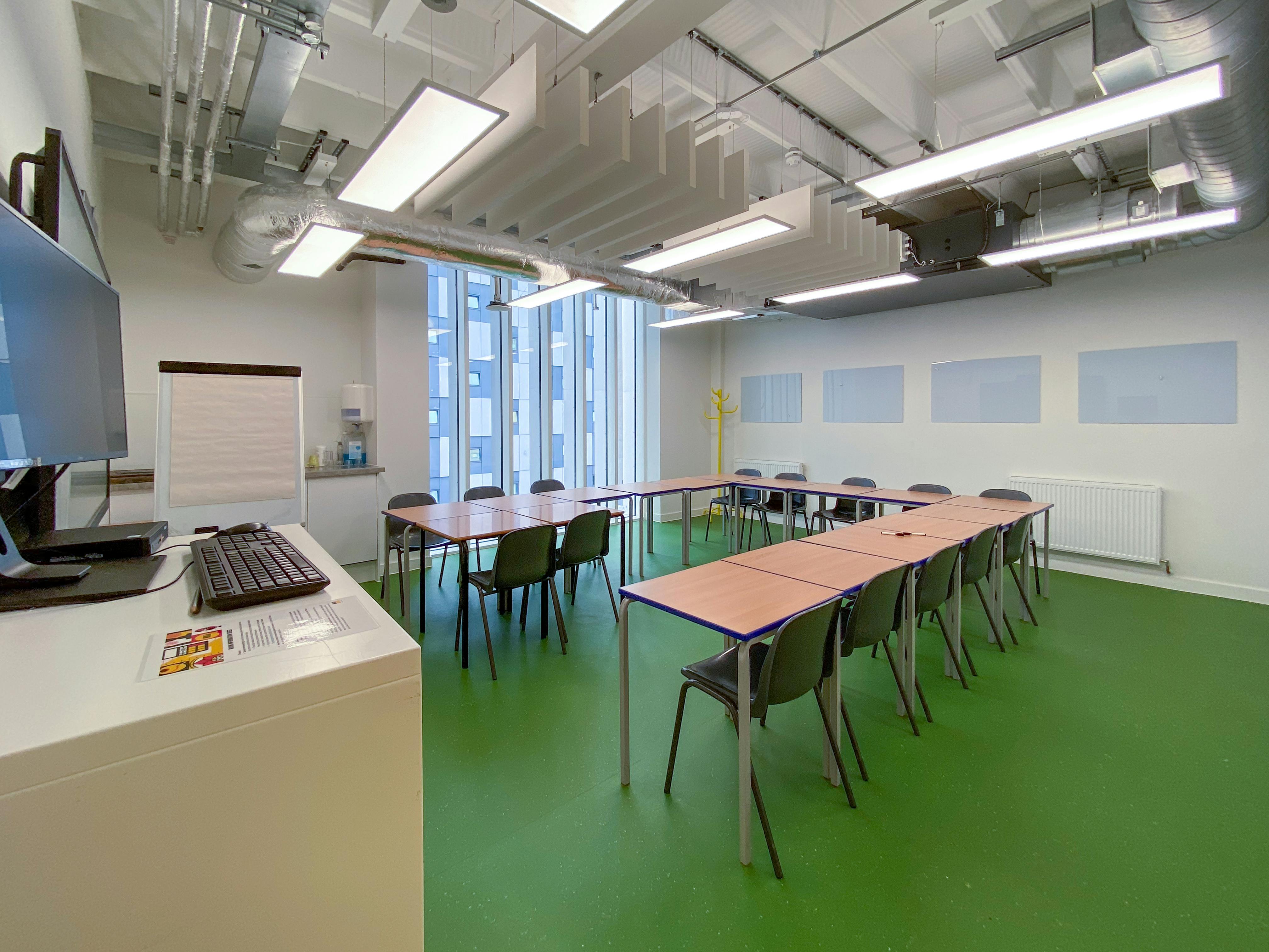 Well-lit meeting room with U-shaped seating for collaborative sessions at Mary Ward Centre.
