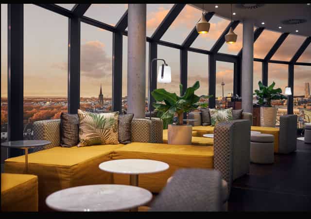 Rooftop terrace at Wasserturm Hotel featuring modular lounge seating for networking or cocktail events.