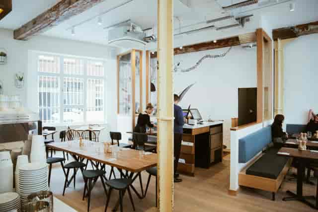 Industrial-chic cafe with communal seating, perfect for corporate workshops and networking events.