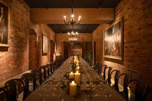 Atmospheric banquet setup in Waddesdon Winter Garden for corporate dinners and private galas.