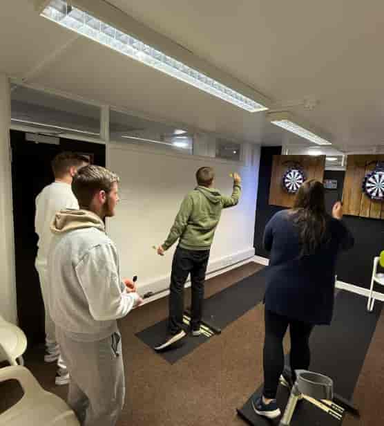 Team-building icebreaker in a casual private event room for corporate workshops.