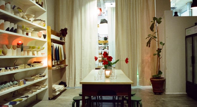 Minimalist OSTUDIO wine bar event space with soft drapes for boutique dinners and workshops.