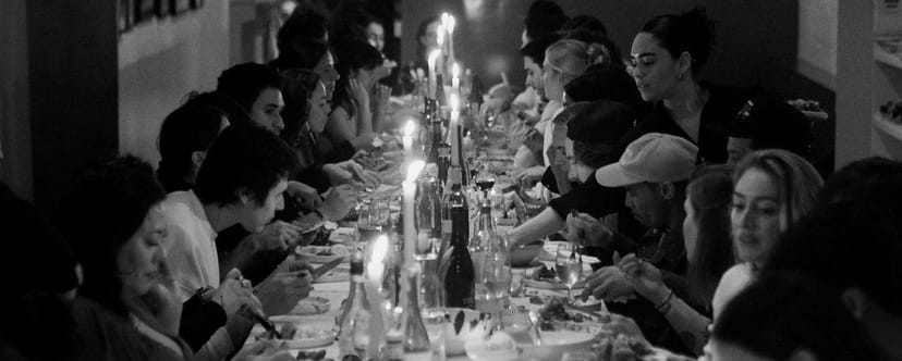 Candlelit long-table dinner at OSTUDIO wine bar, perfect for corporate events and private parties.