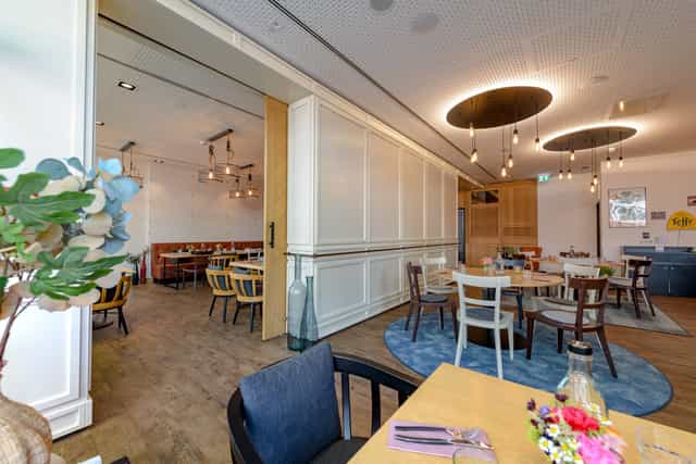 Private dining room with movable partition for corporate events and intimate meetings.
