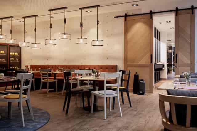 Private dining room at Hotel Mondial am Dom with warm lighting for corporate events and mixers.