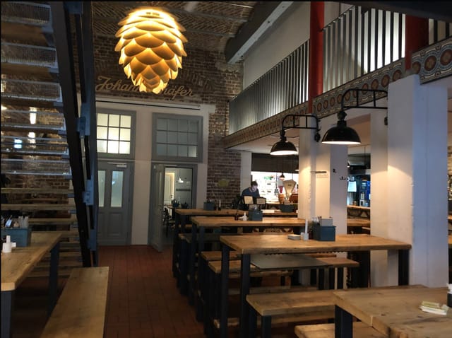 Industrial-chic dinner space with rustic bench seating for networking events and team building.