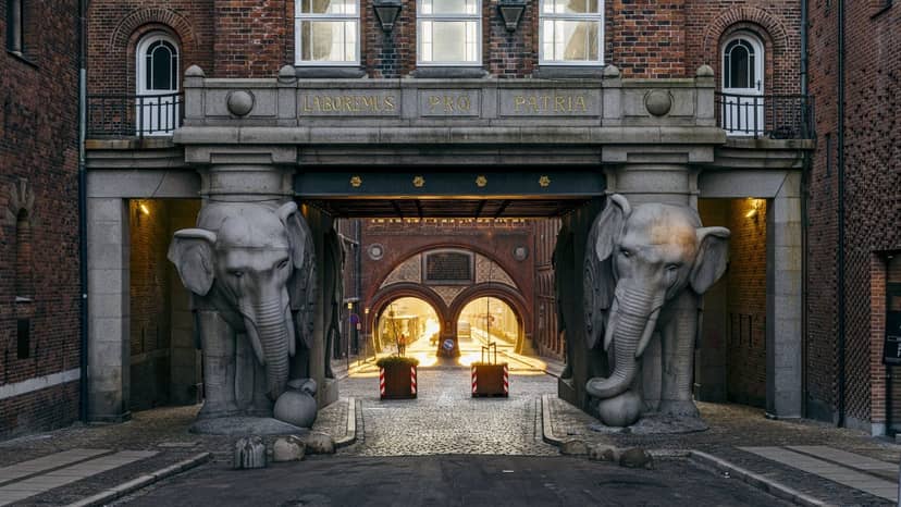 Carlsberg Museum entrance with elephant sculptures, ideal for elegant events and gatherings.