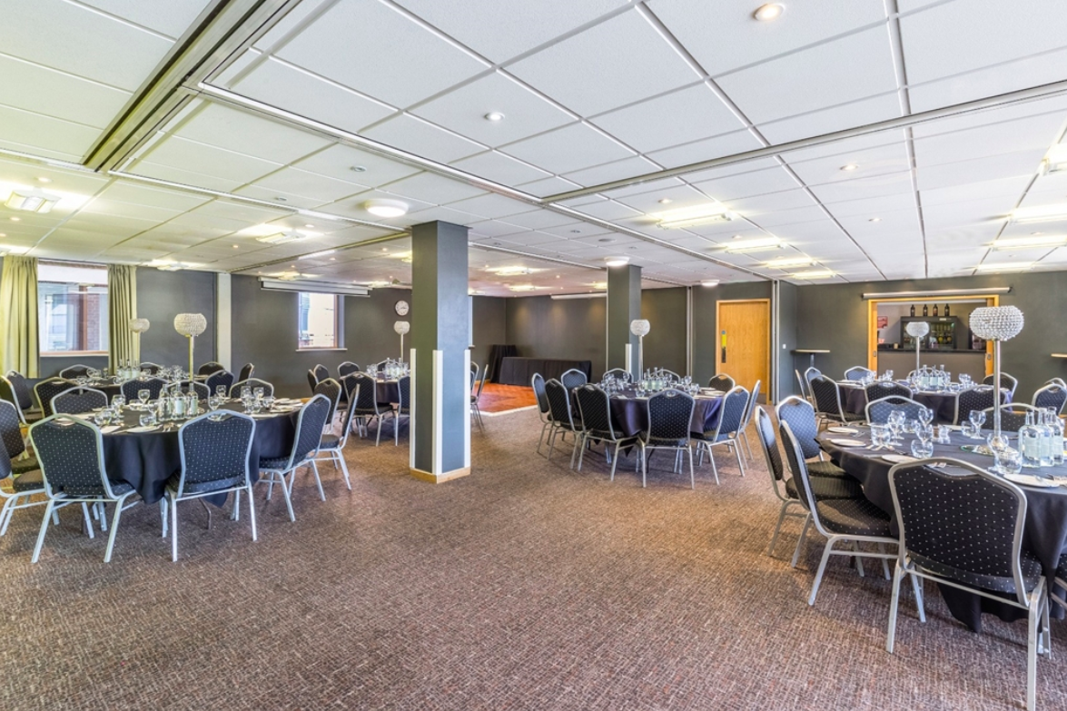 Banquet-style meeting room at Park Inn Peterborough with structural pillars for event planning.