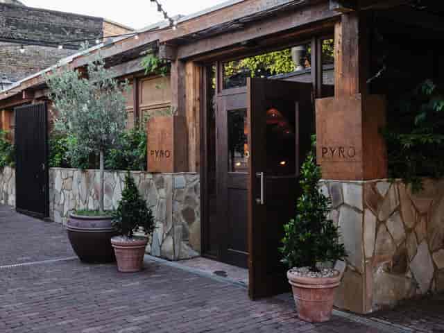 Charming entrance of Pyro Restaurant, ideal for upscale networking events and gatherings.