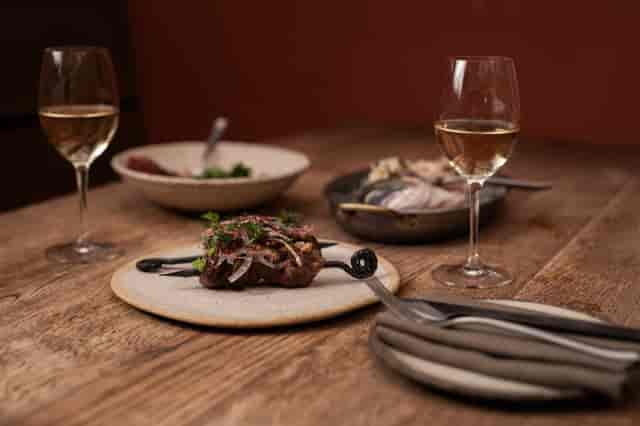 Elegant dining table at Pyro Restaurant with gourmet dishes for upscale events.