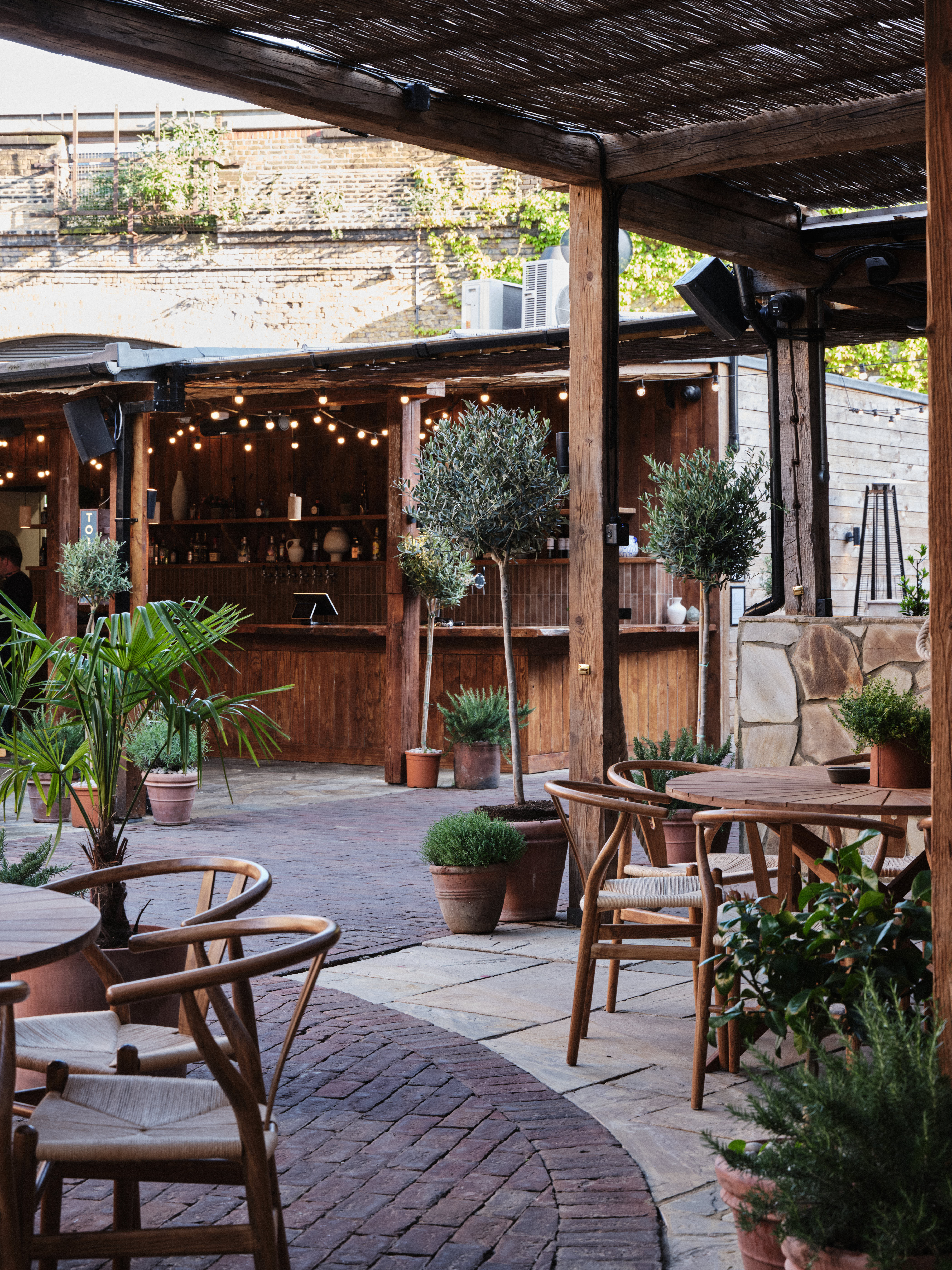 "Charming outdoor venue with cozy bar for casual gatherings and networking events."