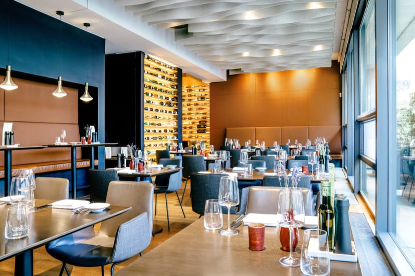 Upscale restaurant dining room with modern décor, ideal for corporate events and networking.