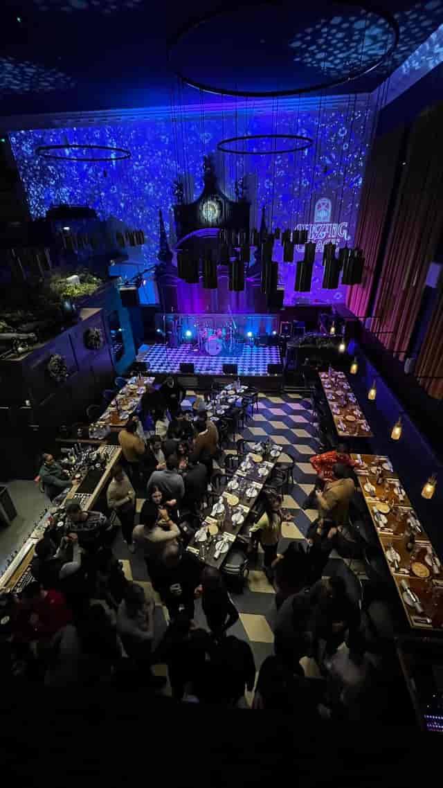 Vibrant Mezzanine event space with stage, ideal for corporate gatherings and celebrations.