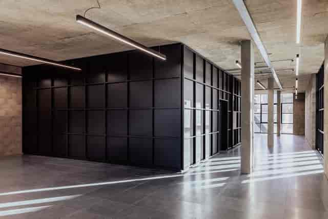 D4 Activation Space: Industrial-chic breakout area for modern networking and exhibition events.