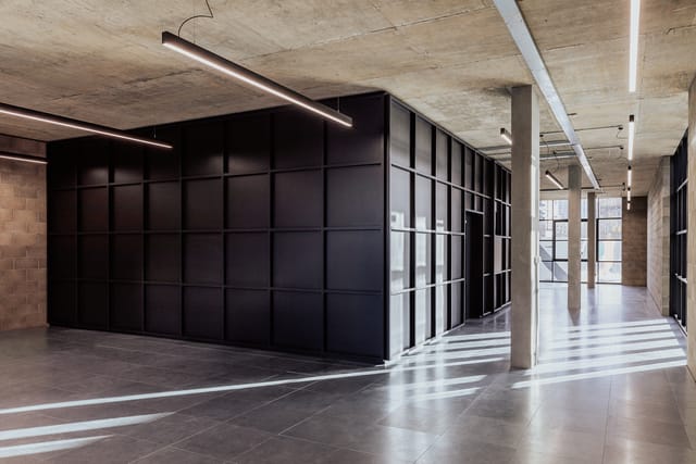 D4 Activation Space: Industrial-chic breakout area for modern networking and exhibition events.