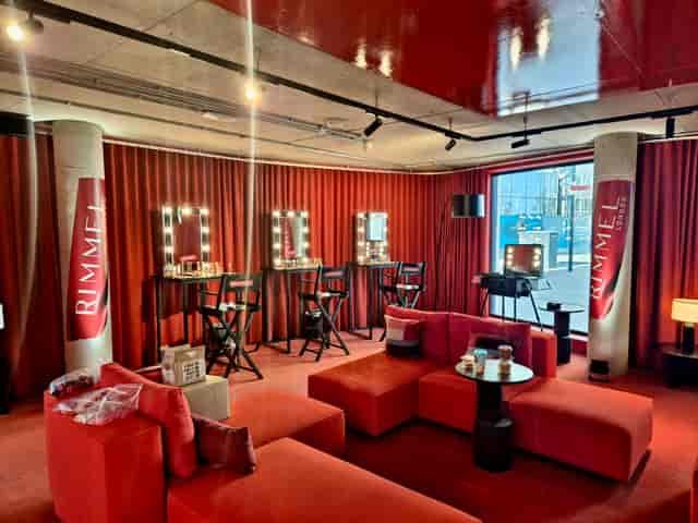 Red branded salon suite for influencer makeup styling and high-end brand activations.