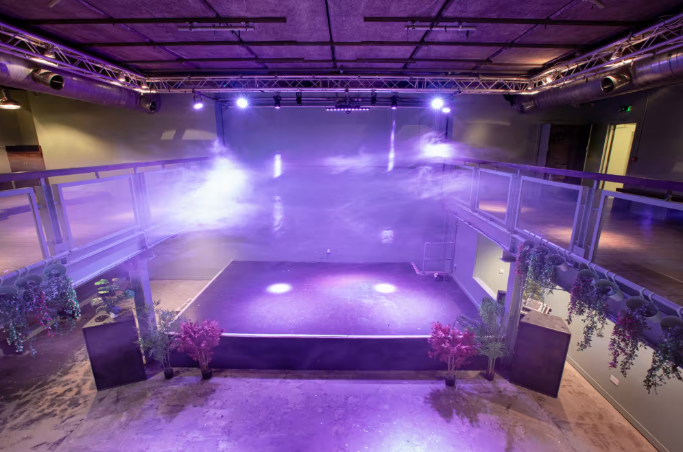 Acres23 industrial-chic event venue with stage, ideal for product launches and modern receptions. - Banner