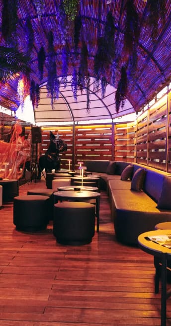 Intimate lounge with modular banquette seating for evening reception or private event venue.