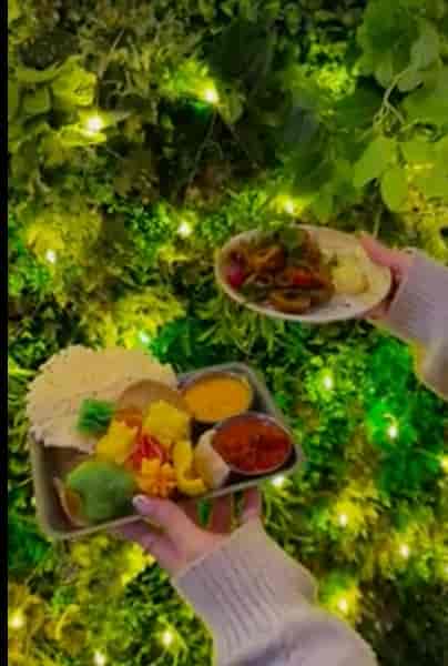 Kerala Canteen dining area with lush green wall for event catering and corporate networking.