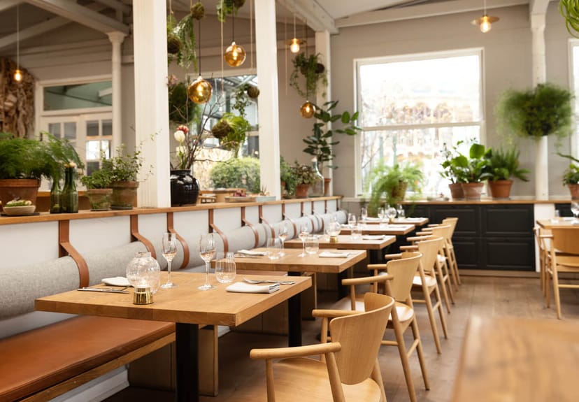 Biophilic dining space at Restaurant KILDEN for corporate dinners and VIP networking events.