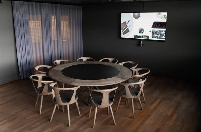 Minimalist boardroom at Almanak with circular table for VIP strategy sessions and focus groups.