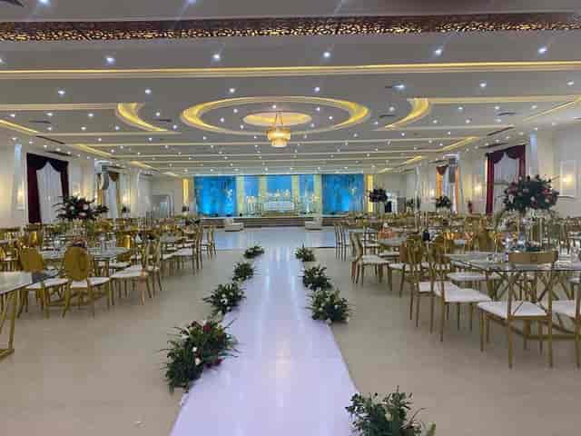 Masiani Hall ballroom with gold seating and stage lighting for wedding or formal event venues.