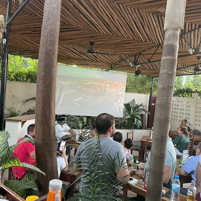 Outdoor cafe event at The Slow Leopard with projector screen for professional networking.