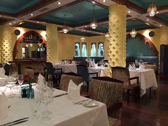 Upscale dining room with arched alcoves, ideal for corporate dinners and social events.