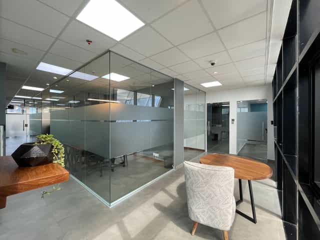Modern ZO Premium breakout area with glass meeting rooms for professional board meetings.