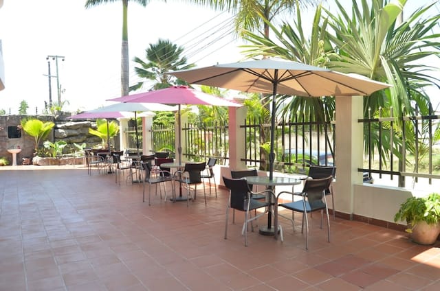 Outdoor restaurant at Doubleview Hotel with minimalist seating for networking and coffee breaks.