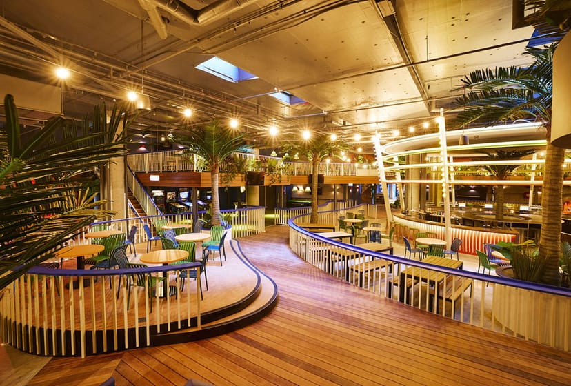 Moon Dog Craft Brewery industrial event space with tropical decor for networking and cocktails.