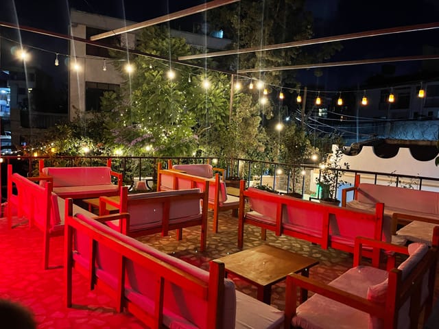 Terrace lounge with ambient lighting, ideal for professional networking mixers and receptions.