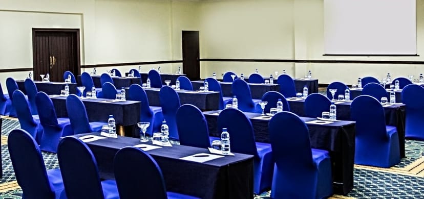 Hifadhi Hotel classroom-style meeting room with blue linens for corporate training events.