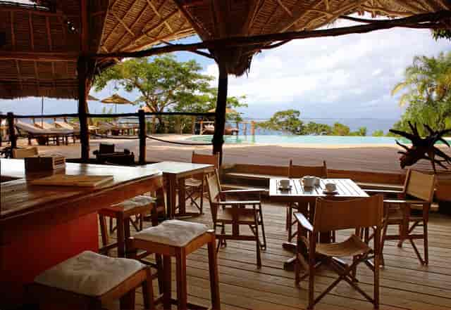 Open-air restaurant at Fundu Lagoon with thatched roof for executive retreats and incentive travel.