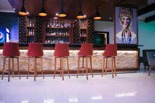 Outdoor hotel bar seating for evening networking and conference cocktail receptions.