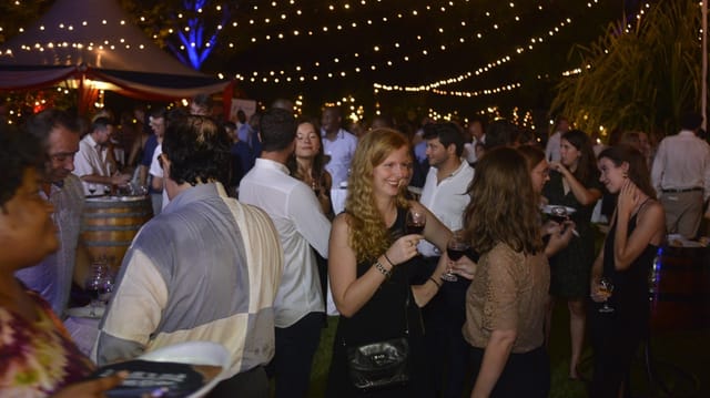Networking reception at Alliance Française Dar es Salaam courtyard with ambient string lighting.