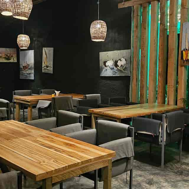 Modern restaurant event space with rustic tables for networking dinners and board meetings.