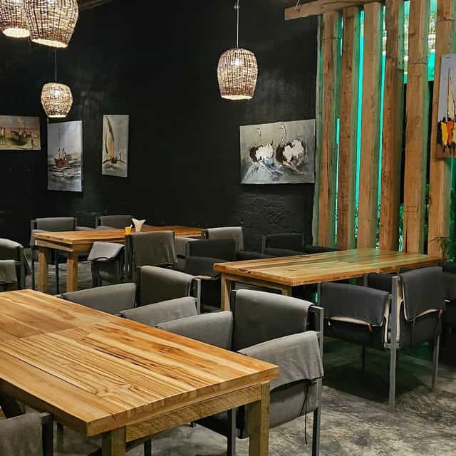 Modern restaurant event space with rustic tables for networking dinners and board meetings.