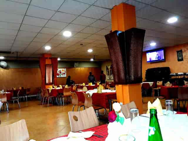 Nino’s Restaurant banquet hall with orange columns, perfect for corporate events and meetings.