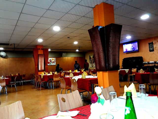 Nino’s Restaurant banquet hall with orange columns, perfect for corporate events and meetings.